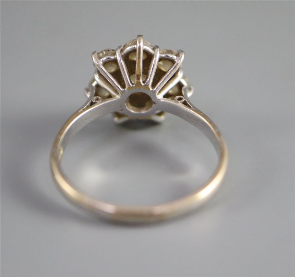 A modern 18ct white gold and eight stone diamond cluster flower head ring,